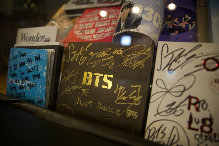 Explore Jimin's roots in Busan through personal memorabilia and stories connecting with the local culture and the humble beginnings of BTS’s beloved star.